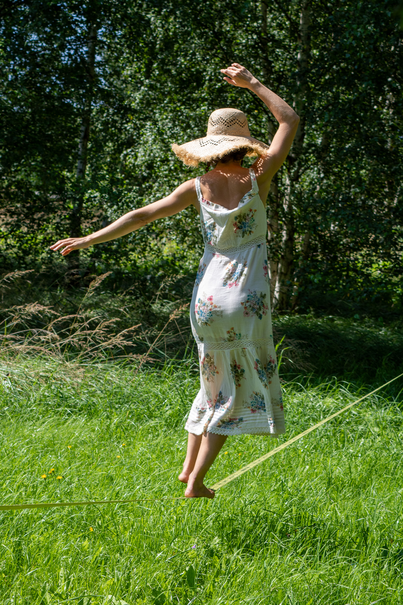 Victoria carrying handmade cups through a birch grove